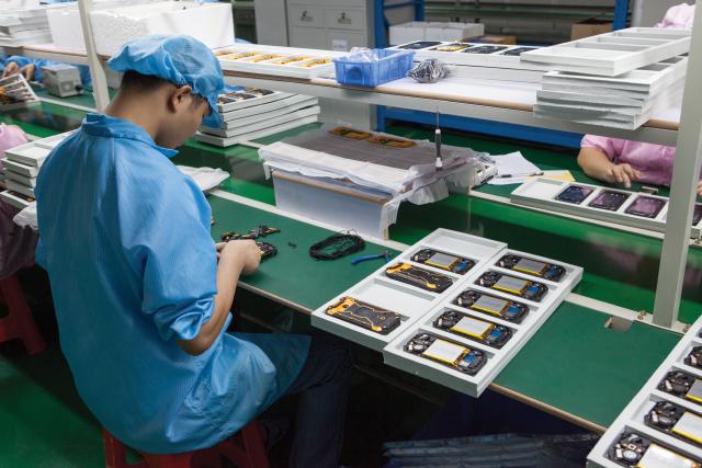 SWELL workers assembling waterproof rubber seals on X8 rugged phones