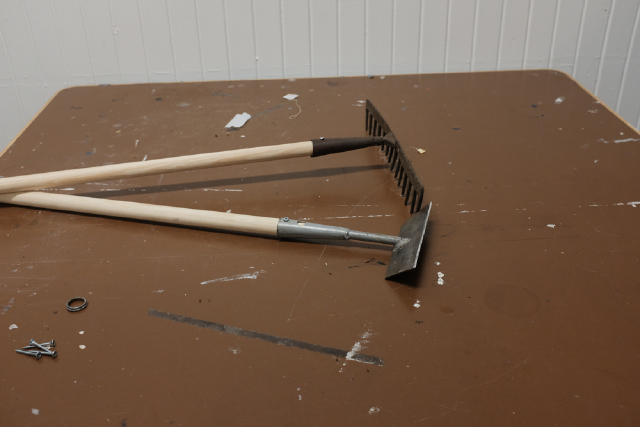 Rake and hoe, sharpened, straightened and refitted with a handle.