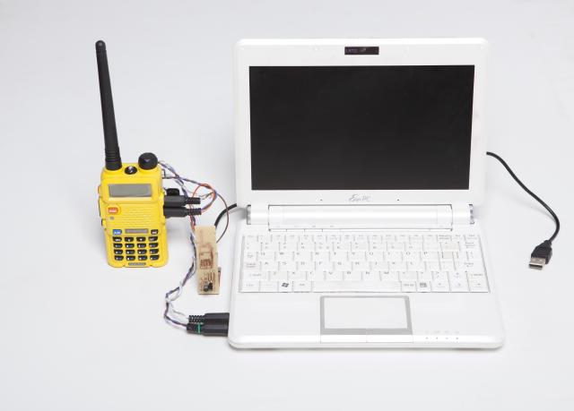 a baofeng radio connected with to an eee-pc laptop with weird custom cabling